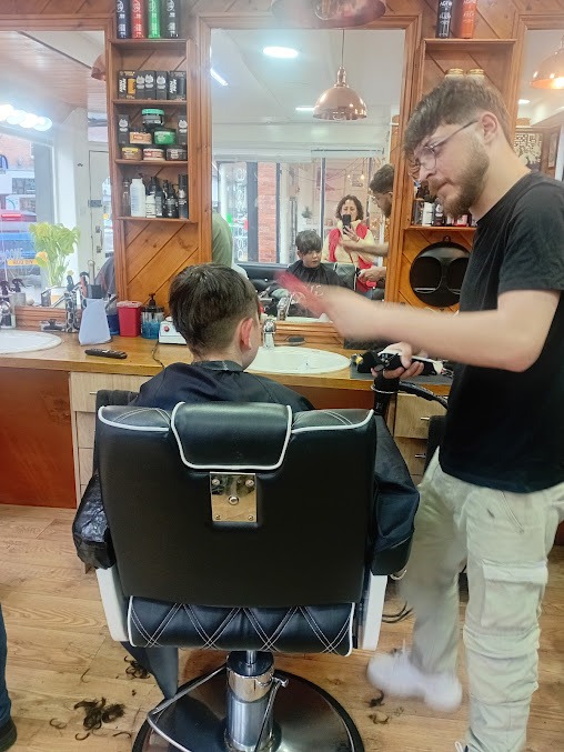 Barber finishing a fresh cut